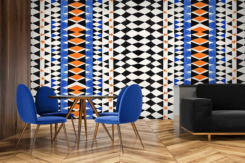 A bold geometric wallpaper with a harlequin design features black, white, blue, and orange patterns.