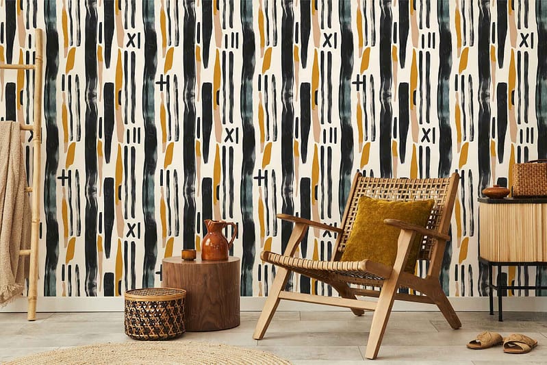 Geometric pattern wallpaper with intricate shapes. Features muted hues of mustard, gray, and cream. Subtly textured background adds depth. Ideal for creating a warm, inviting atmosphere in a cozy corner setting.