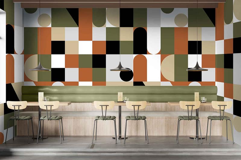 Colorful geometric-patterned wallpaper; shades of green, black, orange, and white.