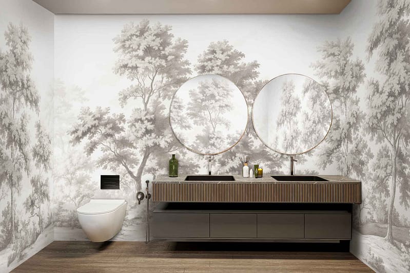 A wall mural of trees featuring lush green foliage, intricate tree trunks in shades of brown and gray, and dappled sunlight filtering through the leaves. The design evokes a serene natural landscape with deep greens, soft browns, and hints of gold illuminating the forest scene.