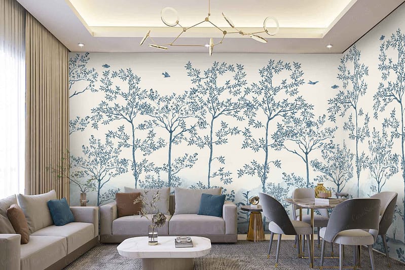 The mural wallpaper features stylized trees and birds. The design includes elements like elongated tree trunks, abstract branches, and minimalistic bird shapes. Color palette highlights include earthy greens, soft blues, muted browns, and touches of gold. The background is a gentle cream or off-white tone, balancing the overall aesthetic with subtle sophistication.