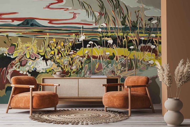 The wallpaper displays a vibrant mural inspired by the Karoo landscape, featuring colorful fields, blooming flowers in warm tones, and a distant blue mountain beneath an open sky.