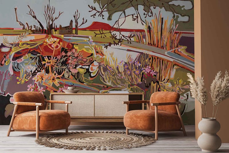 Vibrant Amplify series mural on the wall features abstract plants, water, and trees in bold colors inspired by the Karoo landscape. The wallpaper includes energetic shapes and earthy tones, combining greens, blues, and warm hues for a striking, artistic look.