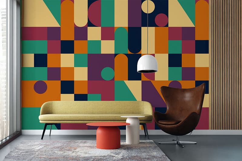 The wallpaper features a geometric pattern with colorful shapes like triangles, circles, and squares. Dominant colors include blue, yellow, pink, and green.