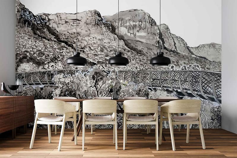 Black-and-white wall mural featuring misty mountains, tall pine trees, and an arched bridge spanning a river or valley. Monochrome tones, grayscale gradients, atmospheric landscape.