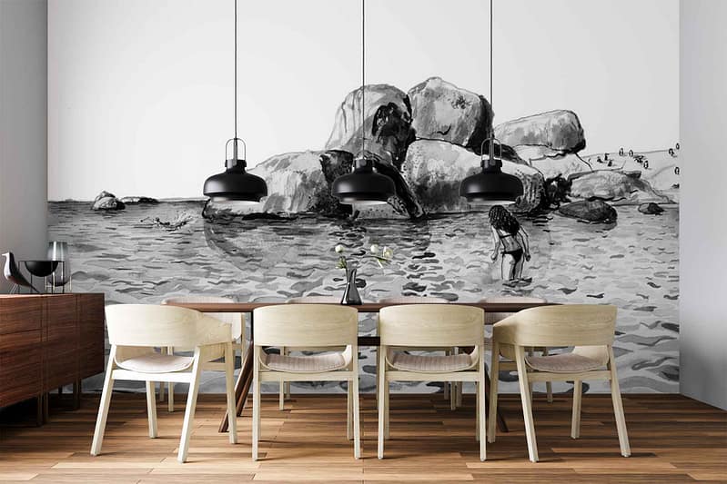 Black-and-white mural wallpaper featuring a rocky shoreline, ocean waves, and people on the beach. Elements include detailed rocks, water textures, and small human figures; color palette is grayscale—varying blacks, whites, and grays.