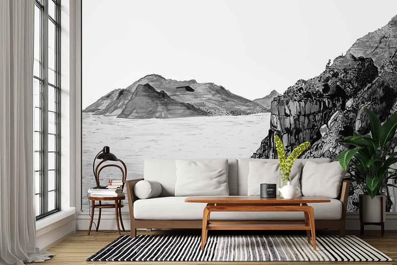 Striking black-and-white wall mural featuring dramatic Cape Point mountains, rugged cliffs, and sweeping ocean water. Monochromatic tones with high-contrast shading emphasize the landscape’s texture and depth. The wallpaper showcases bold silhouettes of rocky peaks against a bright sky and detailed linear patterns representing waves and geological strata.