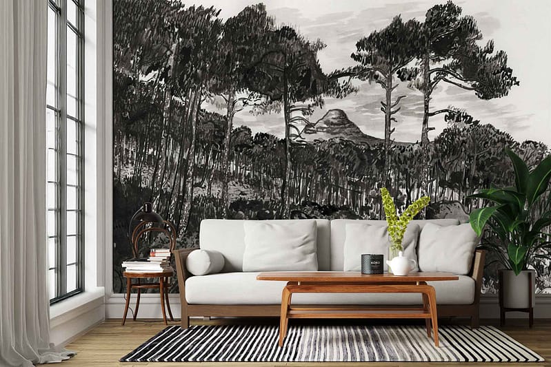 The wallpaper is a large black-and-white mural depicting a forest with tall trees in the foreground and layered mountains in the background. The design uses grayscale tones, featuring detailed tree silhouettes and misty mountain outlines, creating a dramatic monochrome landscape scene.