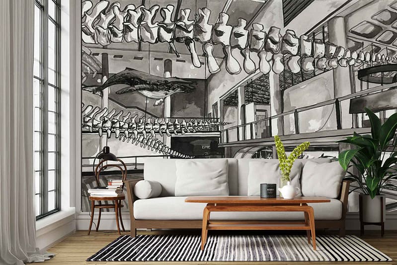 Large-scale black-and-white wallpaper mural depicting a museum interior with dramatic arches, soaring ceilings, and prominent dinosaur skeletons, including long, curving bones and skulls. High-contrast grayscale tones dominate, with intricate architectural details and fossil forms emphasized.