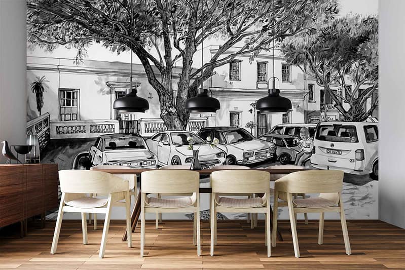 Black-and-white wallpaper mural features a sketch-style illustration of parked cars, leafy trees, and the façade of a building. The design is monochrome with detailed linework, emphasizing urban elements like vehicles, architectural details, windows, foliage, and street features in shades of black, white, and gray.