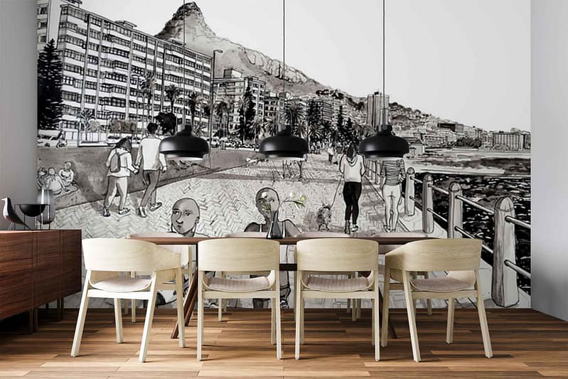 Wallpaper features a vibrant seaside promenade scene, with people strolling along the waterfront, tall modern buildings rising nearby, and a prominent mountain in the background. The mural uses blues and turquoise for water and sky, sandy beige tones for walkways, splashes of green from landscaping, and colorful details in figures’ clothing—creating an energetic coastal city atmosphere.