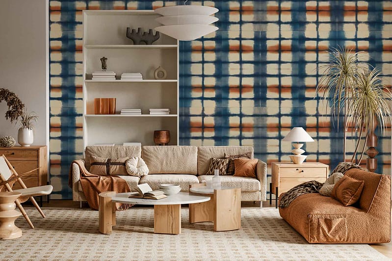 Wallpaper features a plaid design with intersecting stripes in deep blue, vibrant orange, and crisp white, inspired by Orion’s colors. The geometric pattern creates a cozy yet dynamic accent wall, blending cool blues with warm orange tones and clean white lines.