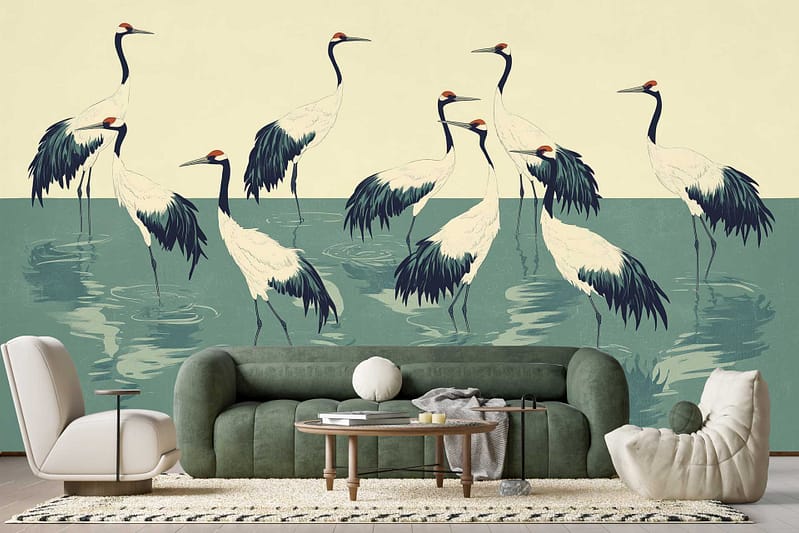 Wallpaper features a large-scale mural of elegant cranes standing in shallow water. The background is minimalistic and artistic, with soft neutral tones—grays, beiges, and subtle whites—accentuating the graceful white cranes with black detailing on their wings and red accents on their heads. Hints of watery reflections and gentle gradient washes complete the serene scene.