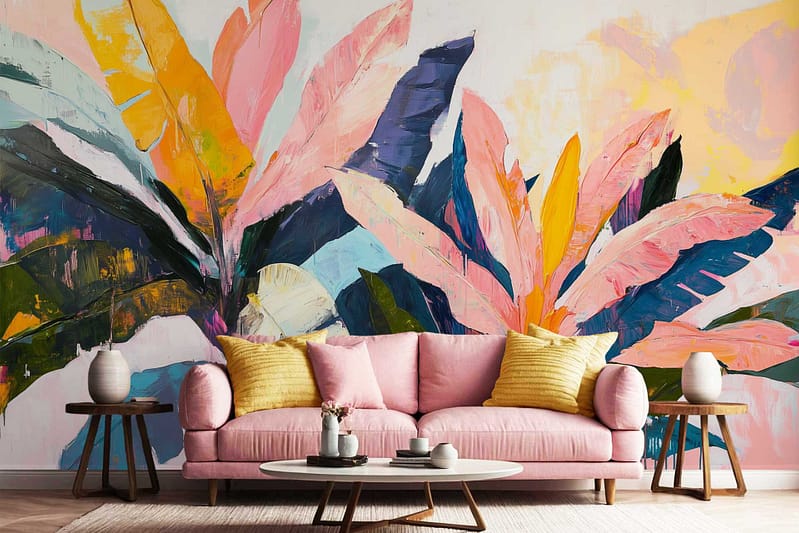Wallpaper features a large mural with abstract tropical leaves and subtle animal shapes. Dominant colors include vibrant pink, yellow, green, and blue tones. Leaf patterns are bold and sweeping; animal forms are softly blended in the background for a playful yet modern look. The design is colorful and lively, serving as an eye-catching accent wall.