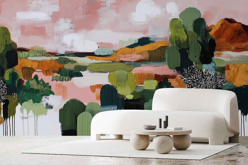Colorful abstract landscape mural called "Resting Mountain" wallpaper features bold green, orange, and pink brushstrokes. The design includes expressive shapes resembling trees, rolling hills, and a vibrant sky. The mural’s composition is dynamic with layered organic forms and playful color blending—greens suggest forested slopes; oranges and pinks evoke sunset-lit hills and airy skies. Ideal for statement accent walls in modern interiors.