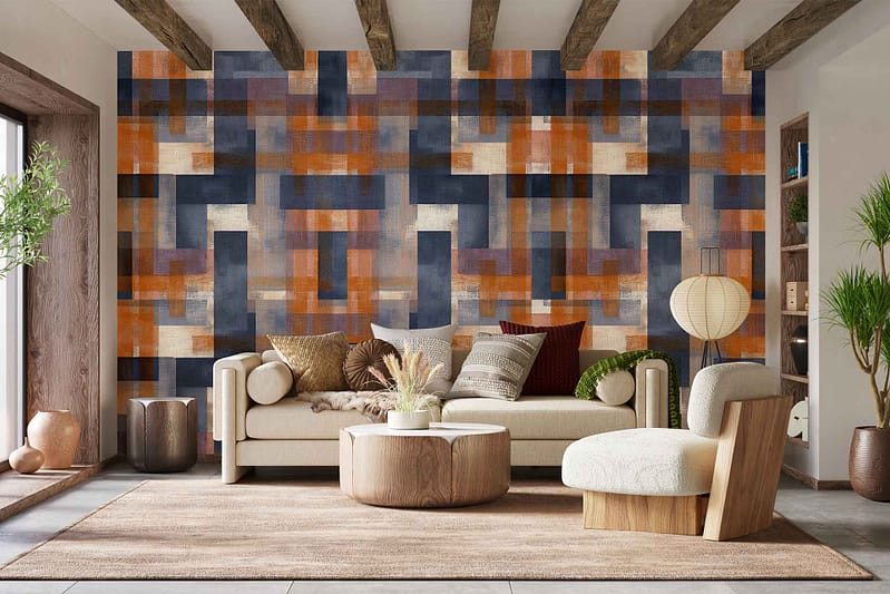 The wallpaper features bold geometric patterns in earthy tones—terracotta, ochre, olive green, and creamy beige. Angular shapes and intersecting lines create a dynamic visual statement that enhances the modern decor.
