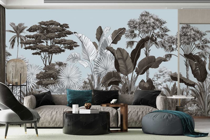 The wallpaper features a mural of tropical trees and oversized leaves in muted tones such as soft greens, pale blues, gentle greys, and subtle taupes. Artistic elements include detailed palm fronds, banana leaves, and layered foliage creating depth. The overall effect is a dreamy botanical landscape with an "On The Loose" relaxed vibe.