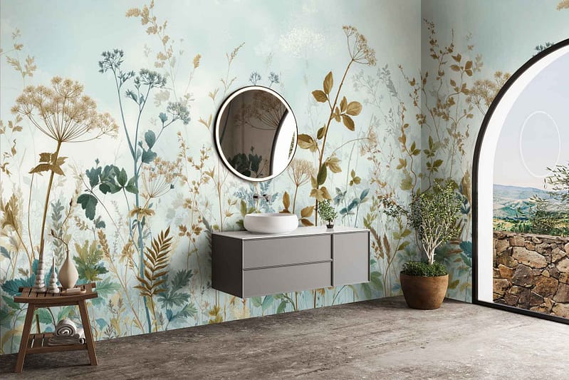Botanical wallpaper featuring lush green leaves, delicate ferns, and subtle eucalyptus branches intertwined with muted pastel flowers. The color palette includes deep forest green, sage, soft blush pinks, creamy whites, and hints of golden yellow. Patterns are layered for a natural, organic texture with occasional touches of watercolor blue mimicking mountain mist.