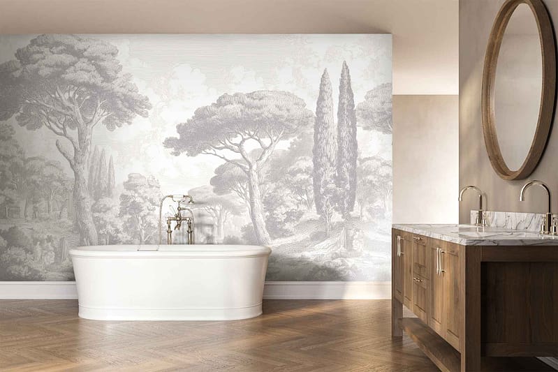 The wallpaper features a large-scale mural of serene trees and a scenic landscape in muted, earthy tones—soft grays, gentle greens, taupe, and beige. Delicate branches, leafy canopies, rolling hills, and subtle horizon lines create a calming nature-inspired backdrop that evokes tranquility. The design uses watercolor textures and washed-out shades for an elegant yet understated look.