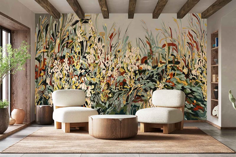 A wall covered in a colorful, abstract floral mural inspired by Fynbos, featuring bold shapes and vibrant hues such as pink, green, yellow, and blue. The wallpaper’s botanical elements and lively patterns create a striking focal point in the room.