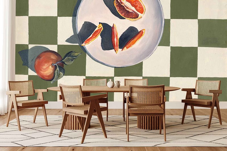 Wallpaper with a large mural of sliced citrus fruit and a whole orange set against a green and white checkered pattern; dominant colors include orange, yellow, green, and white.