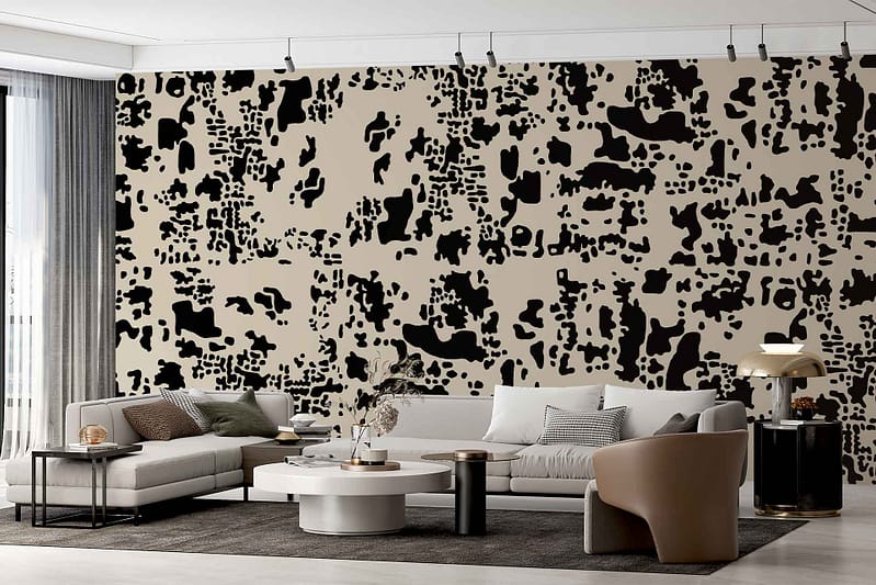 The accent wall features a bold, abstract wallpaper inspired by The Procession, showcasing vibrant shapes and dynamic patterns in vivid colors such as deep blue, bright yellow, and rich red.