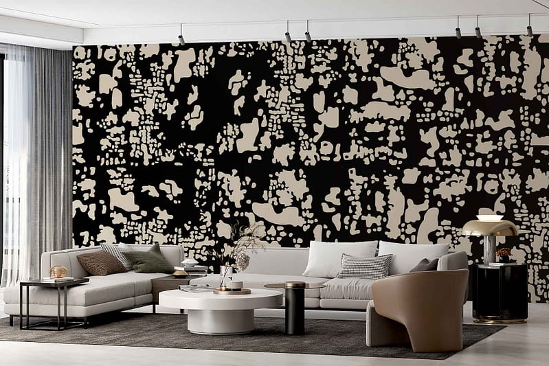 Bold black-and-beige abstract patterned wallpaper featuring striking geometric shapes and fluid lines. The design combines dramatic black with warm beige for visual contrast, making the accent wall a standout element in the room.