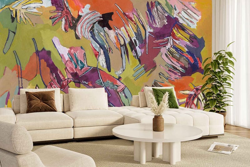 The wallpaper features "Contemplating Winter," a bold, colorful abstract mural with sweeping strokes of deep blues, vibrant oranges, and cool greys. Dynamic shapes and contrasting colors create an eye-catching focal point behind the living room furniture.