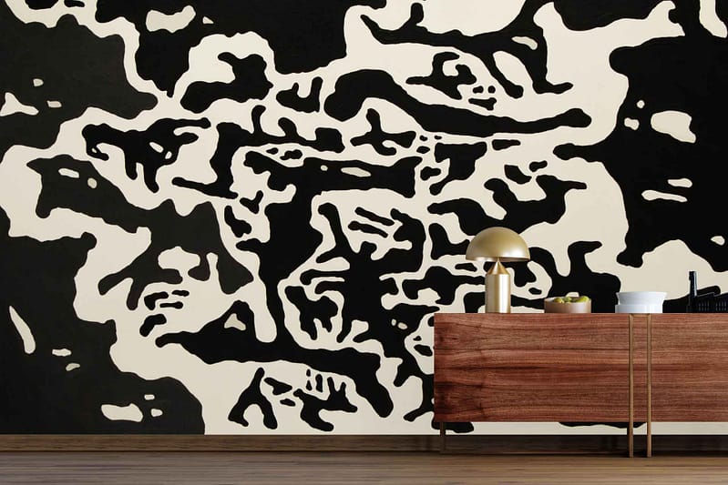 Abstract black and white wallpaper with organic, irregular shapes resembling ebony root. The mural features bold monochrome patterns and undulating forms, emphasizing abstract art in black and white.