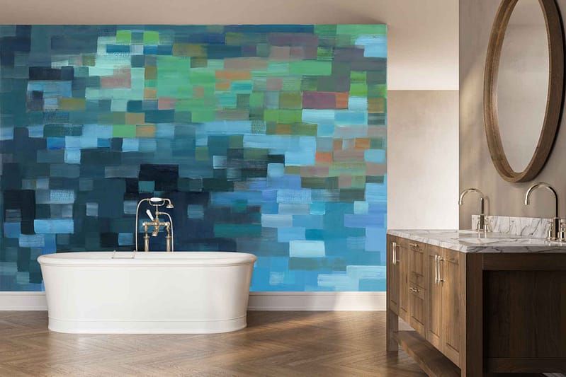 Feature wall with blue and green mosaic tiles forming an abstract mural, showcasing overlapping organic shapes in various shades of teal, navy, turquoise, and emerald with occasional white accents.