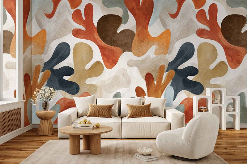 Bold, abstract wallpaper featuring multicolored leaf-shaped patterns in vibrant hues of blue, orange, yellow, green, and red. The design is eye-catching and modern, making a dramatic statement on the wall.