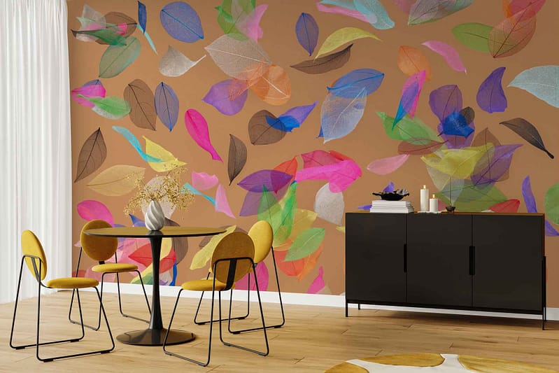 Large mural wall with colorful, translucent leaves in shades of green, orange, yellow, and red over a rich brown background; vivid botanical wallpaper design is the room’s focal point.