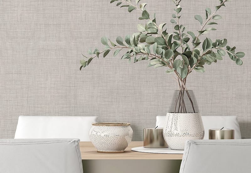 A textured beige wallpaper with subtle patterns serves as the backdrop, adding warmth and a neutral tone to the room.