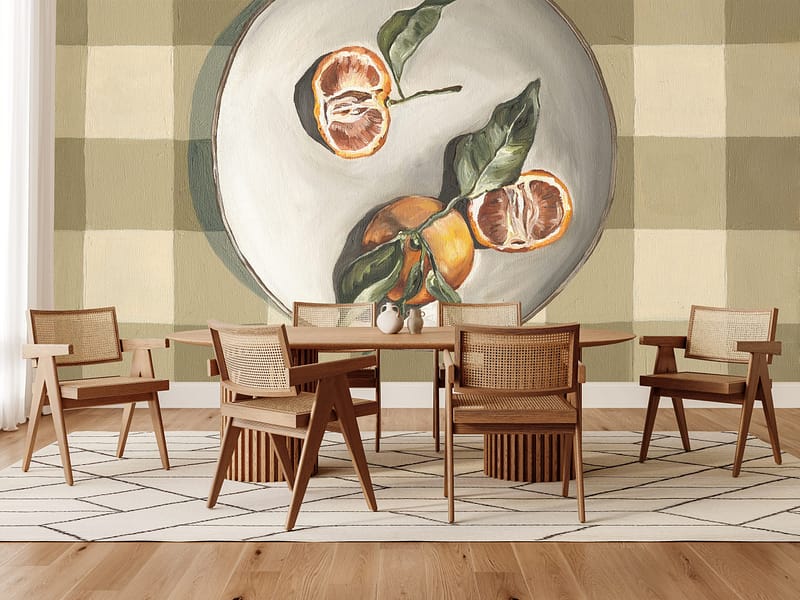 Wallpaper featuring citrus-inspired tones and abstract elements dominates the wall, incorporating soft orange, yellow, and green hues that contribute to a cozy indoor atmosphere.