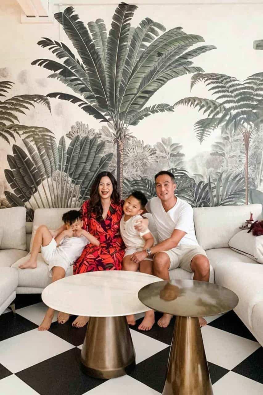 The tropical-themed wall mural features lush green palm leaves, vibrant exotic flowers in shades of pink, orange, and yellow, and touches of deep blue foliage.