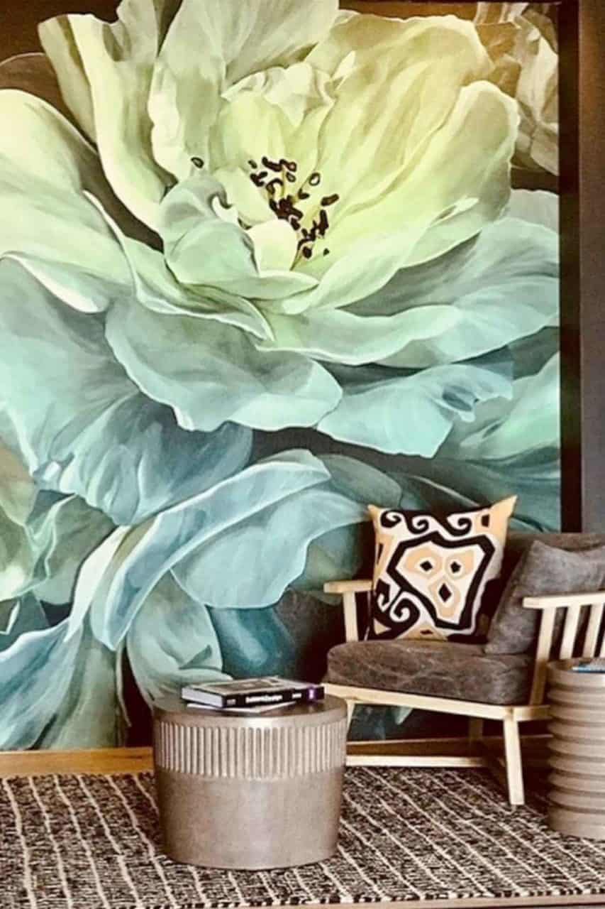 Vibrant mural wallpaper featuring a large, green flower; contrasts with a textured background. Bold colors and intricate design make it an eye-catching focal point in any space.