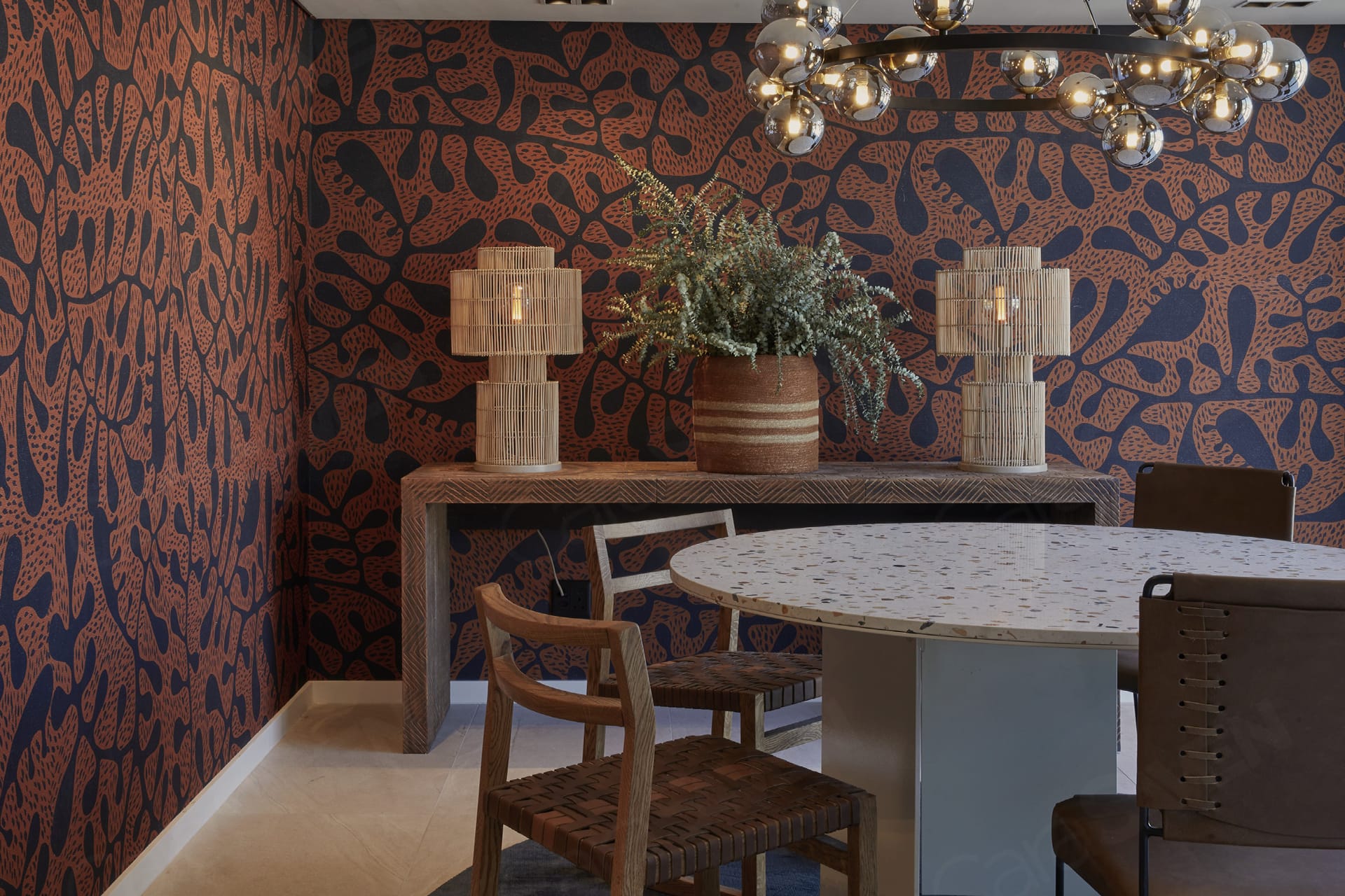 Bold, abstract-patterned wallpaper featuring sweeping shapes and dynamic forms in dark blue and rust tones. The design includes layered curves, painterly brushstrokes, and organic motifs in navy, deep teal, burnt orange, and ochre accents. The overall effect is dramatic and modern with a rich interplay of color blocking and texture.