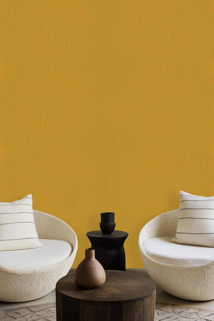 The wallpaper features a rich mustard-yellow color, contributing a bold and contemporary touch to the minimalist interior.