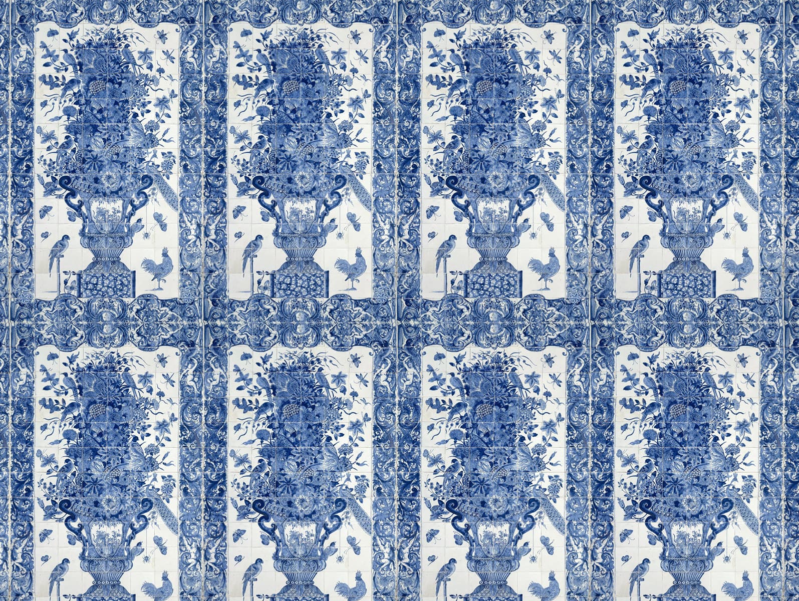 Blue and white wallpaper featuring vertical columns of floral vases, birds, butterflies, and ornate decorative borders. Traditional porcelain-inspired pattern with detailed blue motifs on a white background.