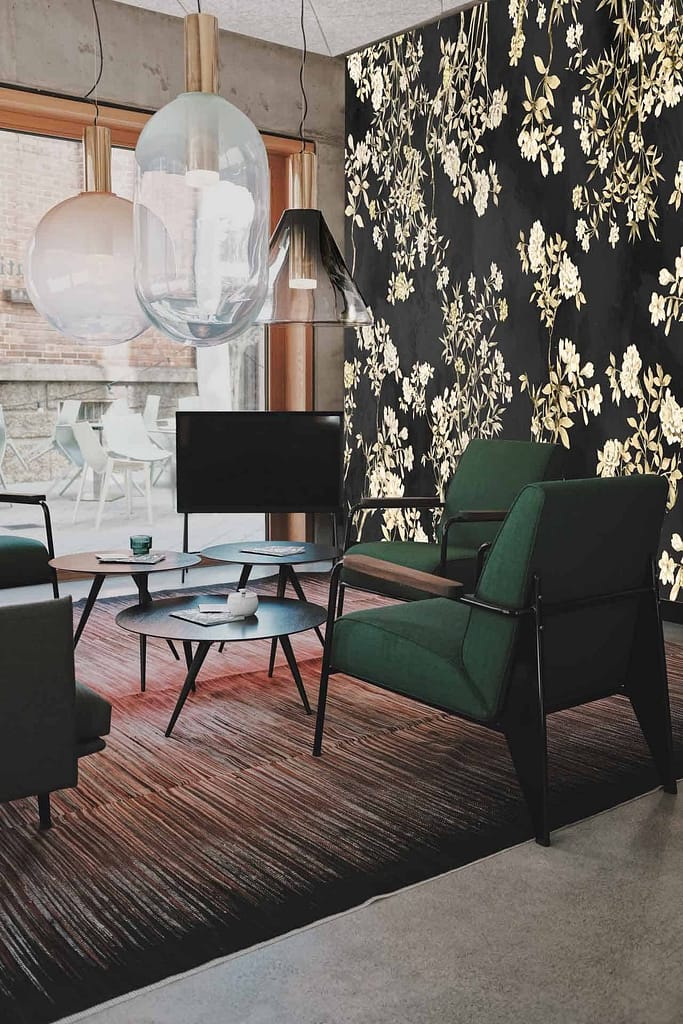 Black and gold floral accent wall featuring intricate patterns of flowers and leaves.