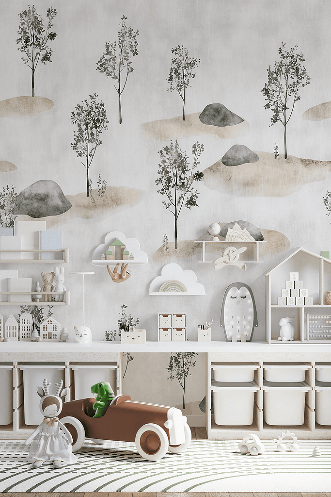 The wallpaper in the pastel-colored children's playroom features a calming tree and mountain theme. The mountains display gentle shades of blue, lavender, and pale green, with white snowcaps. The trees have soft hues of mint green and tender brown trunks. There are delicate touches of pink flowers scattered among the trees, blending harmoniously with the overall serene palette.