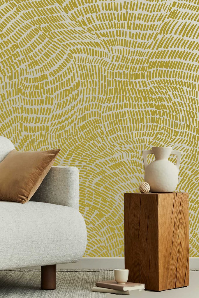 The wallpaper in the Whispering Meadow features a patterned design in yellow and white, creating a warm and inviting ambiance. Its intricate motifs blend seamlessly with the room's cozy aesthetic, adding depth and character to the corner.