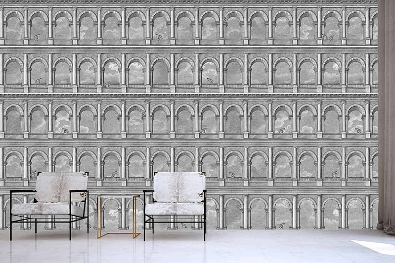 The monochrome wall mural prominently features architectural arches reminiscent of Rome's ancient amphitheater. It primarily uses shades of black, white, and various grays to create depth and texture in the arches. The intricate details of the stonework and shadows enhance its realism, bringing a historical yet modern touch to the room. This mural acts as a bold focal point while maintaining a classic monochromatic palette.