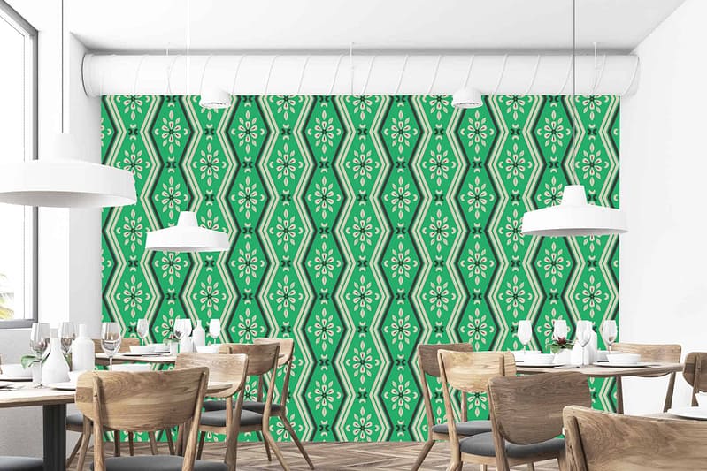 The dining room features a stylish green and white patterned accent wall. The wallpaper consists of intricate geometric shapes interwoven with floral motifs, combining rich forest green hues with crisp white details for a modern yet elegant appeal.