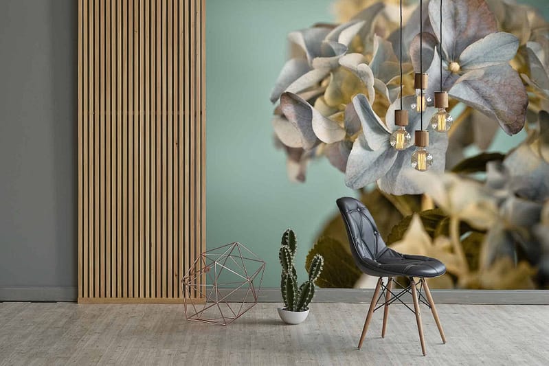 The wallpaper showcases a large floral design featuring an array of detailed petals and leaves in shades of blue, white, and gray.