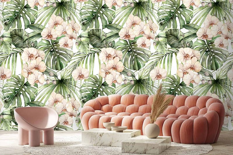 The wallpaper is adorned with a vibrant mix of floral and tropical leaf patterns. Colors include lush greens, soft pinks, bold fuchsias, and hints of creamy whites. Large palm leaves interweave with exotic flowers like hibiscus and orchids, creating an energetic yet harmonious blend of natural elements.