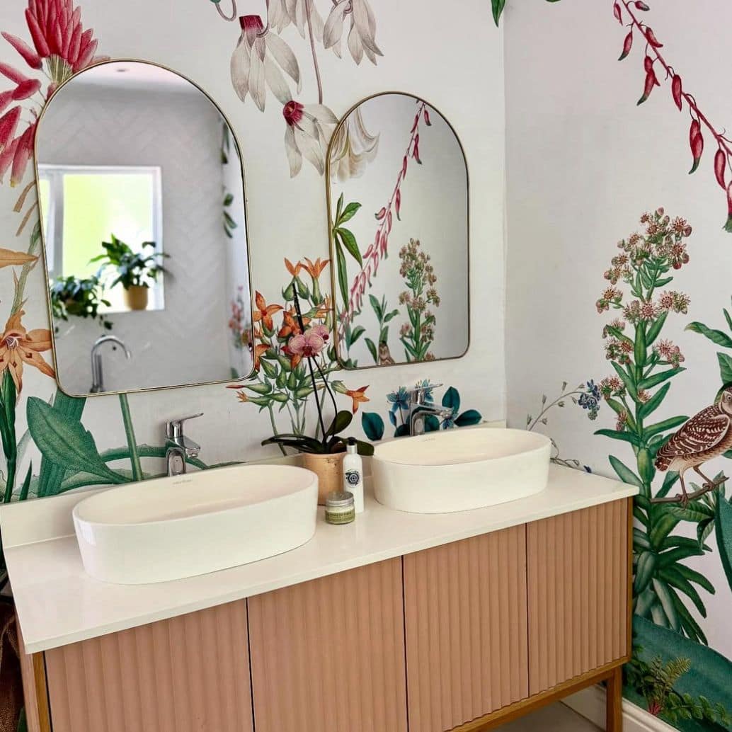 Vibrant floral and bird wallpaper featuring colorful flowers and birds in lively patterns, with bold hues of pink, green, blue, and yellow creating a dynamic focal point in the room.