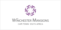 The Winchester Mansions wallpaper features a purple circular motif, elegant script reading "Winchester Mansions," accompanied by "Cape Town South Africa" in refined text. The design evokes a sense of inviting warmth and home-like essence, distinguished by its unique carousel theme. Key elements are the purple circular design and sophisticated typography.