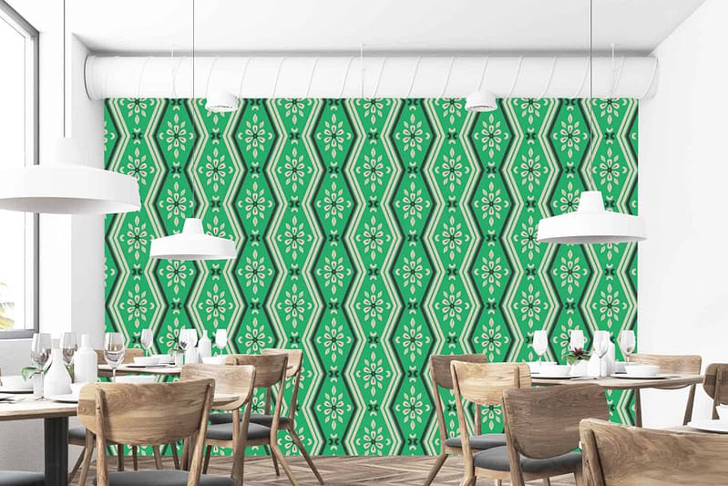 The dining room features a stylish green and white patterned accent wall. The wallpaper consists of intricate geometric shapes interwoven with floral motifs, combining rich forest green hues with crisp white details for a modern yet elegant appeal.