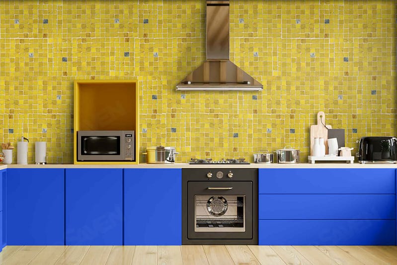 The wallpaper features a dynamic pattern of vibrant yellows and blues, creating depth with varying shades. Key elements include bold geometric shapes, subtle floral motifs, and intricate lines that echo the kitchen's vivid blue cabinets and yellow mosaic tile backsplash. The color palette perfectly harmonizes with the kitchen's modern aesthetic, offering a lively and cohesive look.